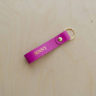 Pink leather keyring with the name "Jenny" written on it in gold foil.