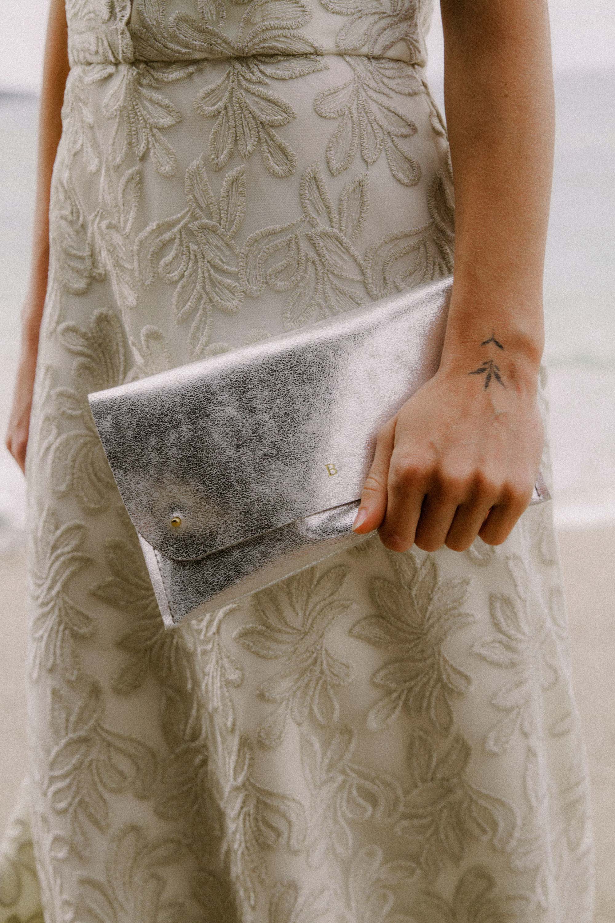 Silver Clutch Bag with personalisation, worn by bride.