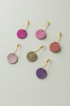 Colourful leather and suede stitch markers for knitting in pinks and purples