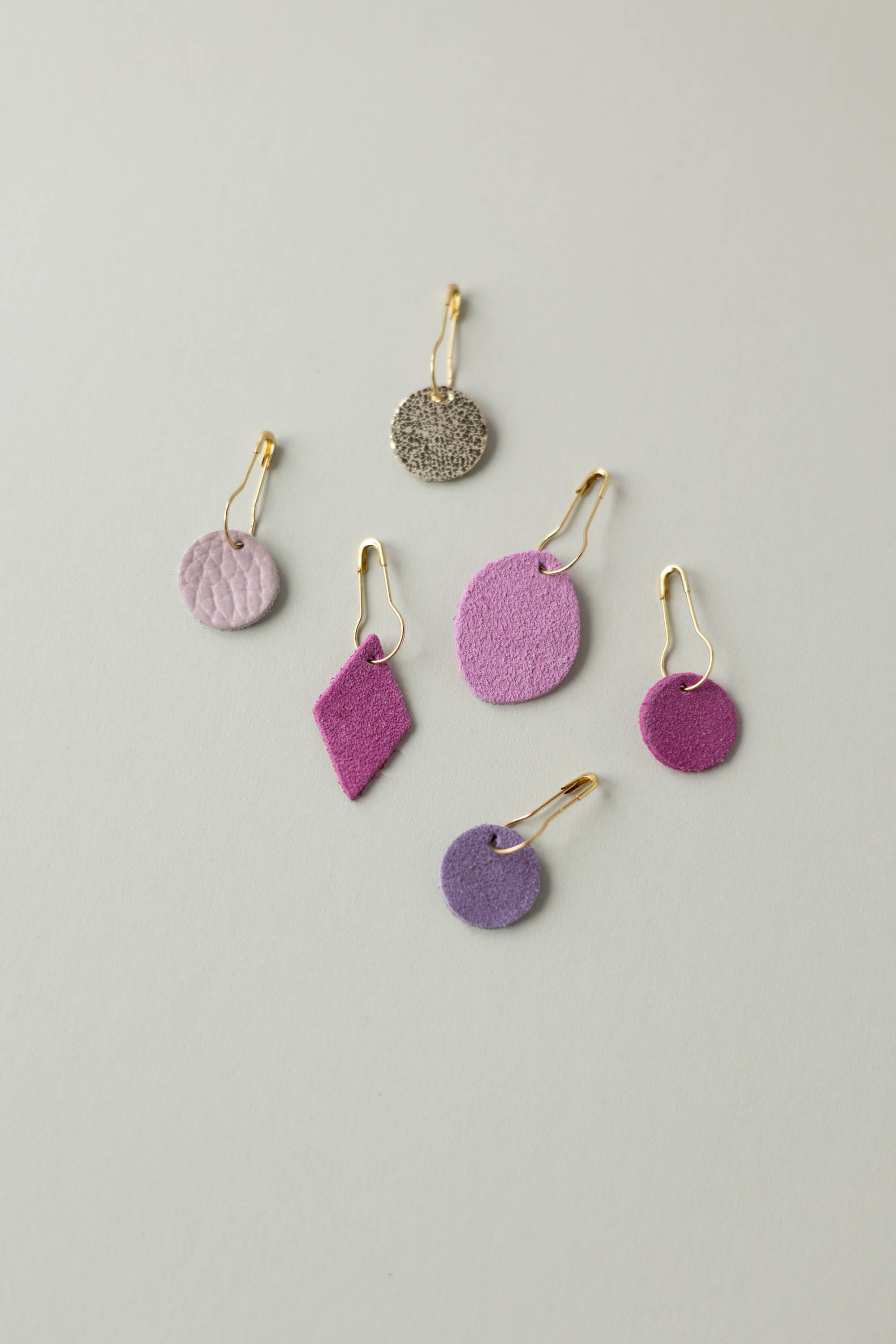 Colourful leather and suede stitch markers for knitting in pinks and purples