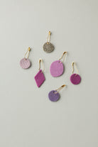 Colourful leather and suede stitch markers for knitting in pinks and purples