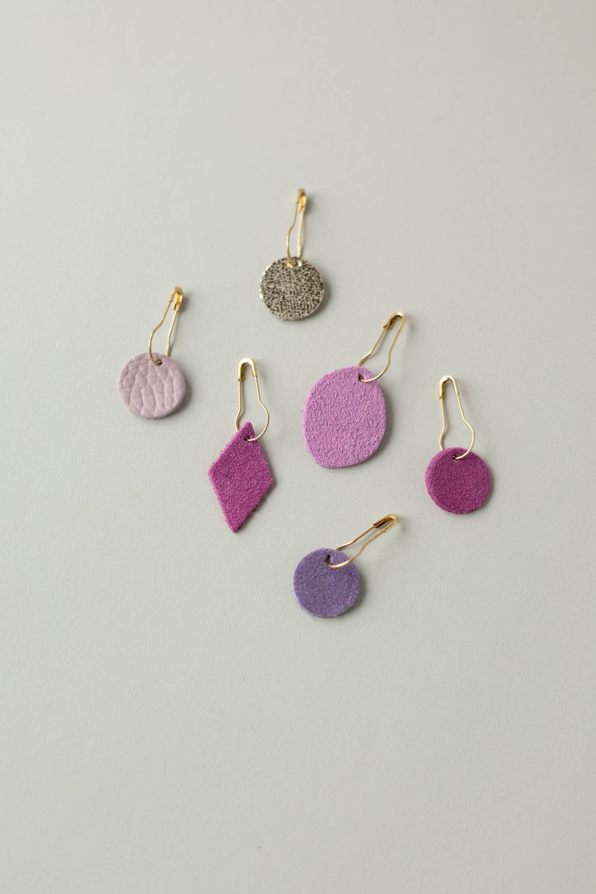 Colourful leather and suede stitch markers for knitting in pinks and purples
