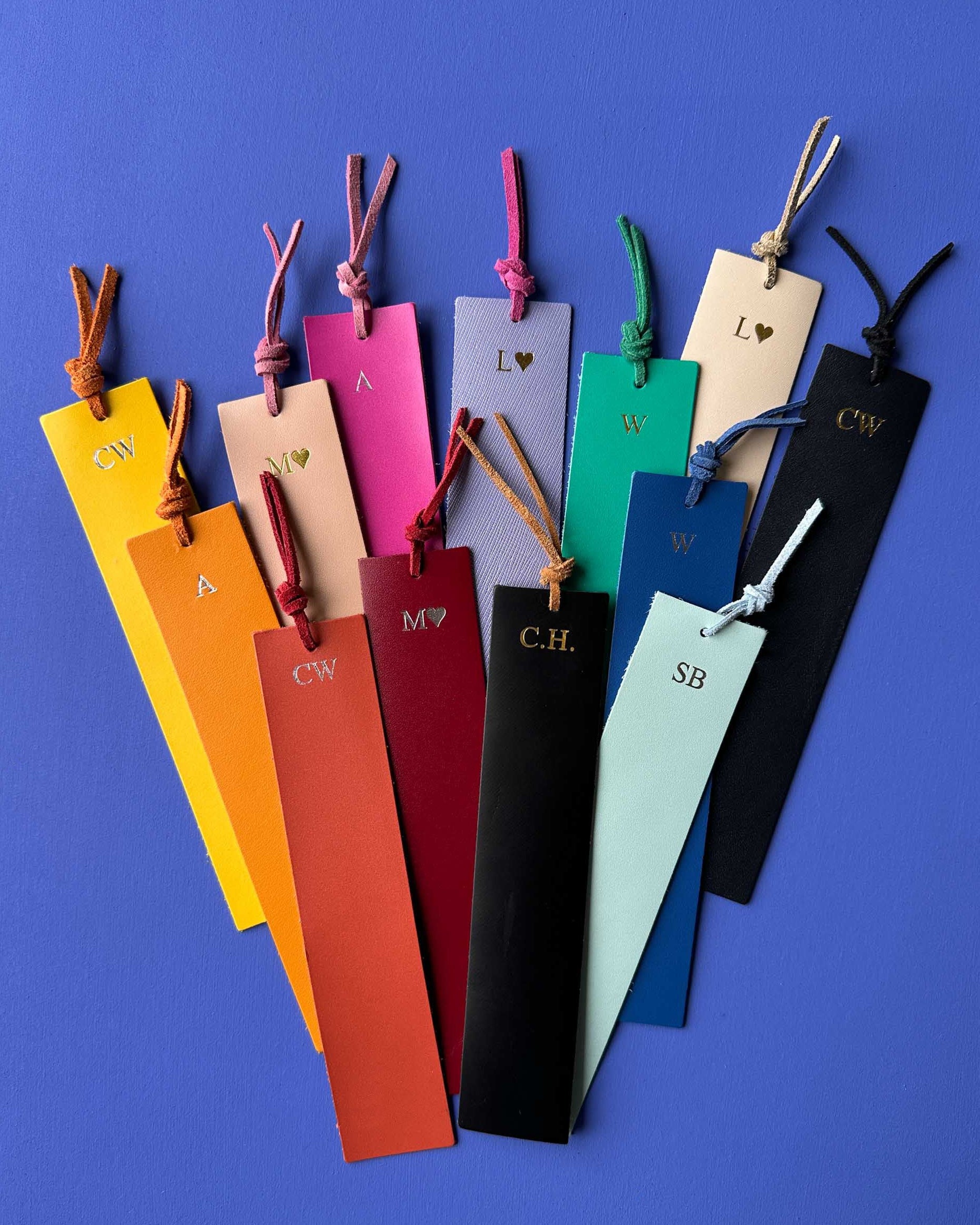 Colorful bookmarks with initials on a blue background