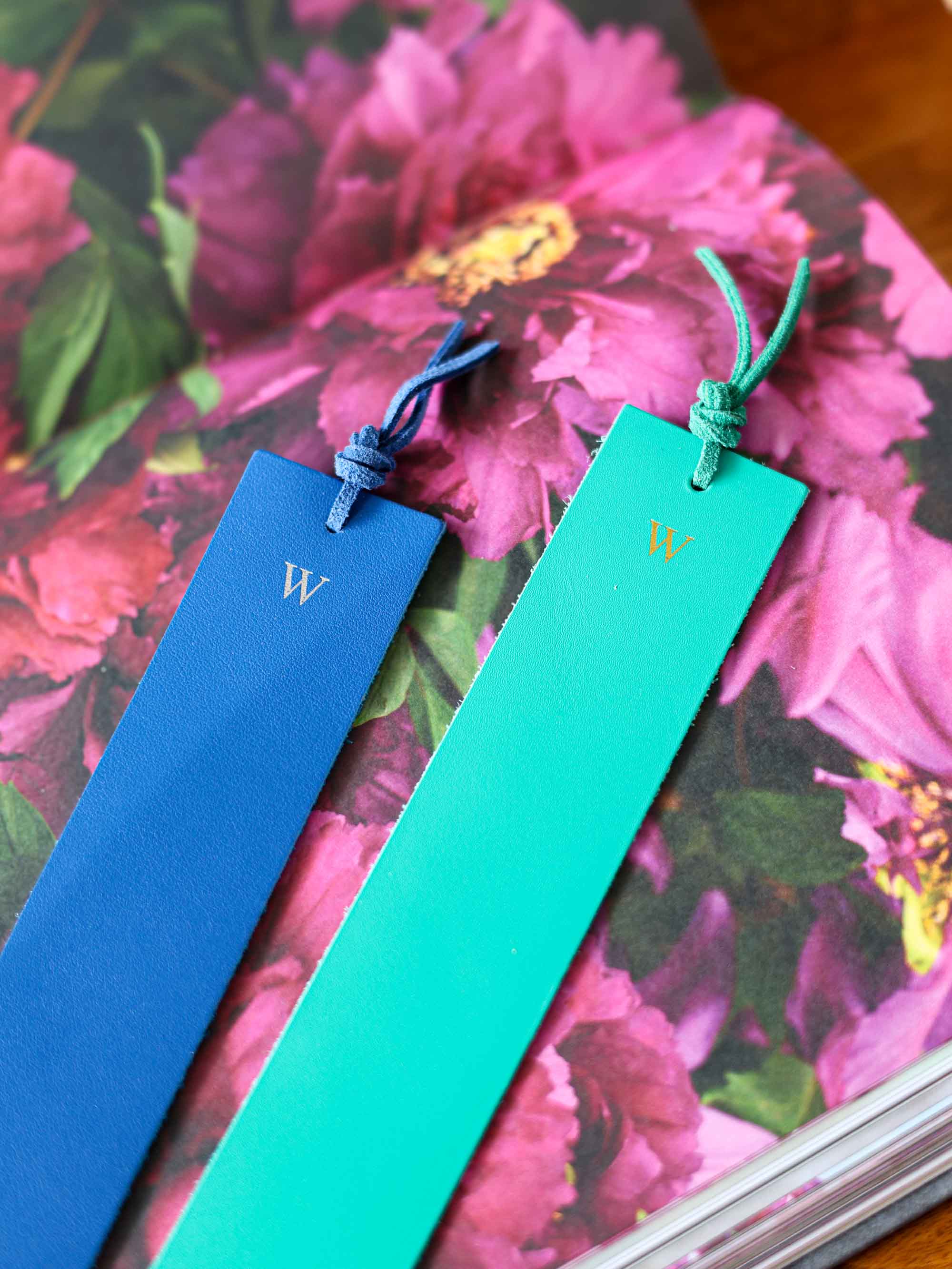 Two bookmarks, one blue and one green, with a 'W' on a floral background.