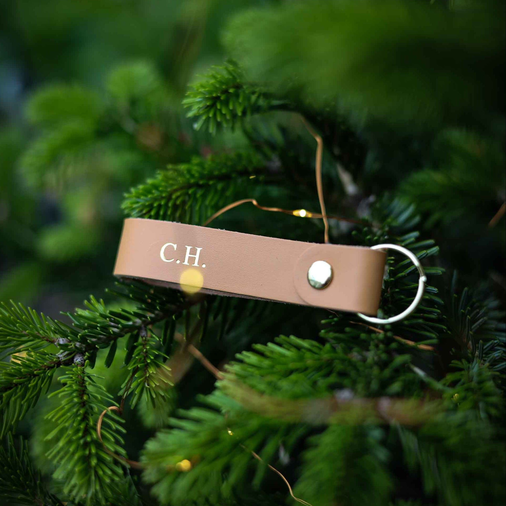 Brown leather keyring with initials C.H. on it.