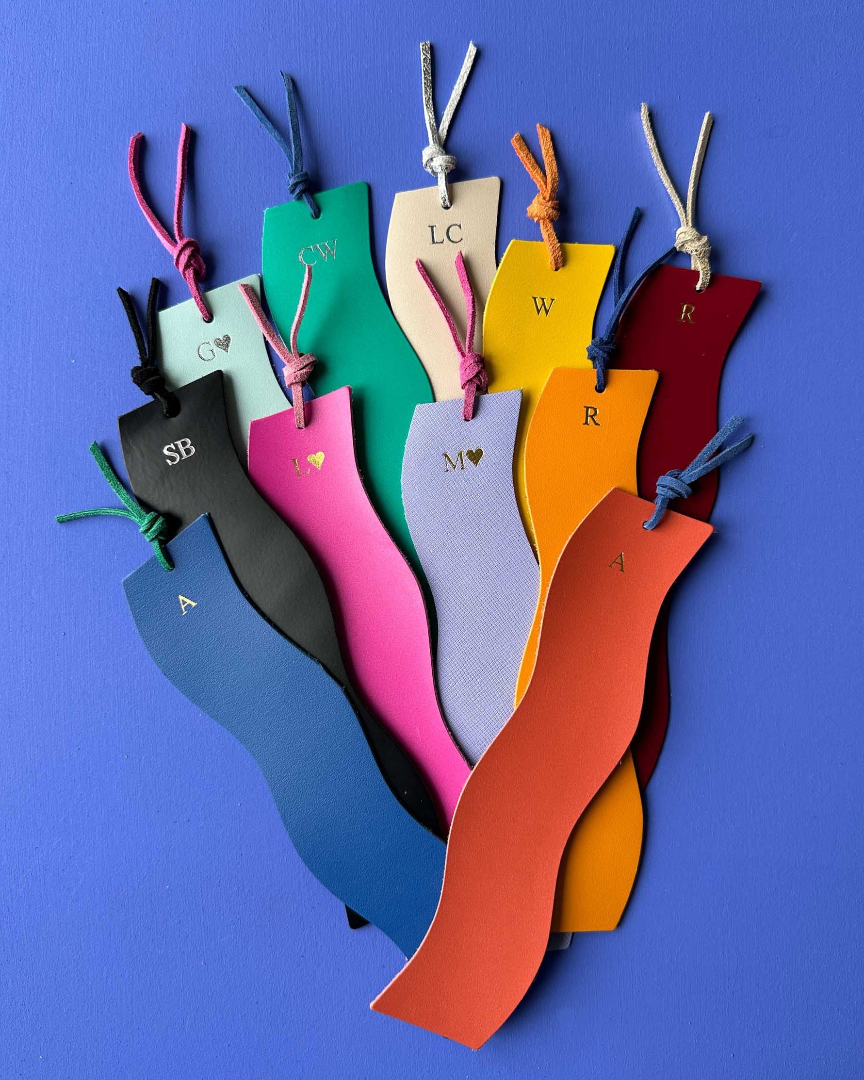 Colorful personalised bookmarks with initials on a blue background