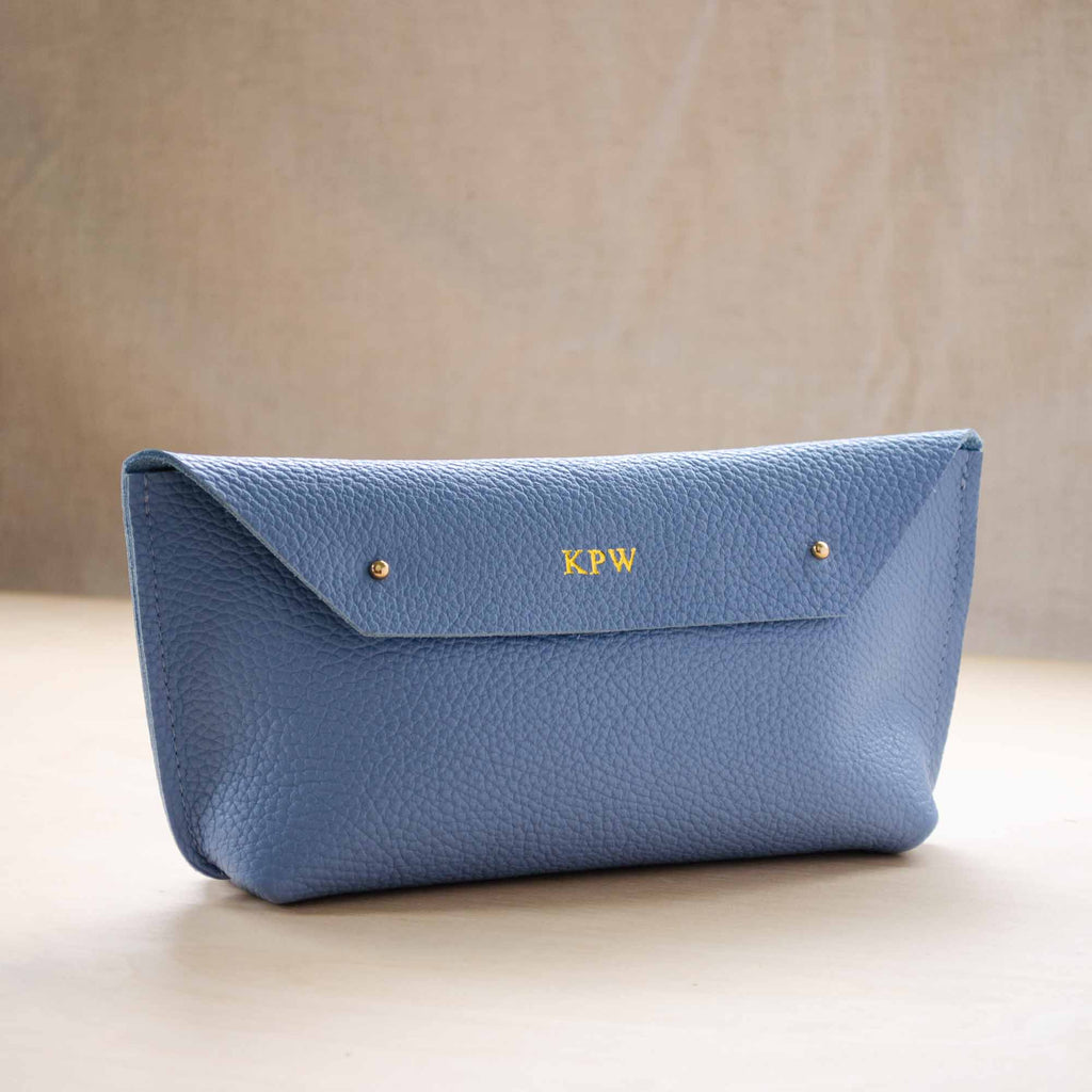 Ailla Leather clutch bag, with gold monogram.