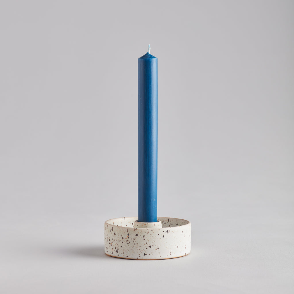 St Eval Bedruthan Blue Dinner Candle in a speckled ceramic candle holder